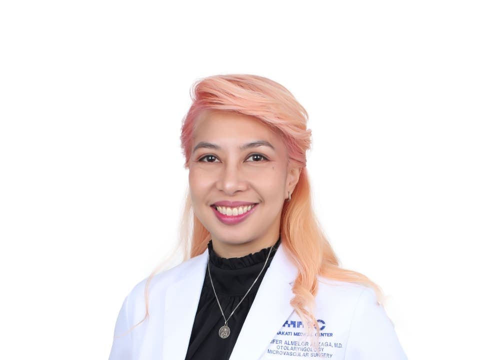 Dr. Jennifer Almelor-Alzaga, ENT and head and neck surgeon in Manila and Makati, standing in her white coat